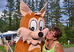 The campground's chipmunk mascot posing with a camper between the sites