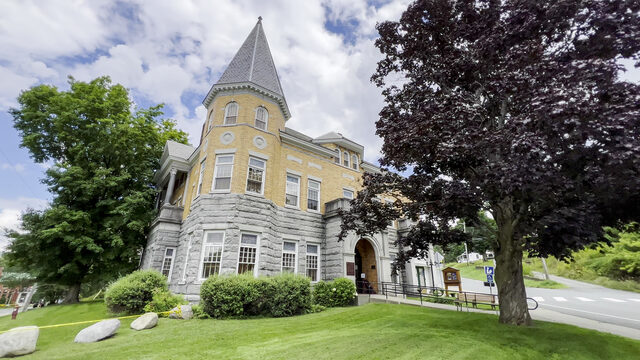 The Haskell Free Library and Opera House, a stone and brick building with a turret, on the Vermont-Quebec border