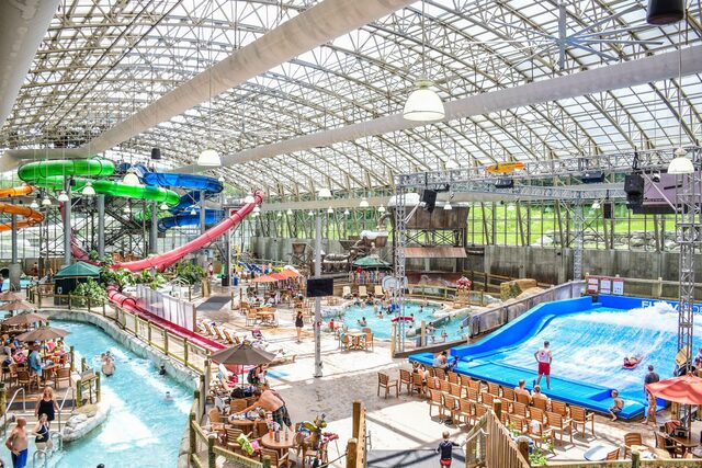 The interior of the Pump House water park at Jay Peak, with slides, a wave pool and a glass roof