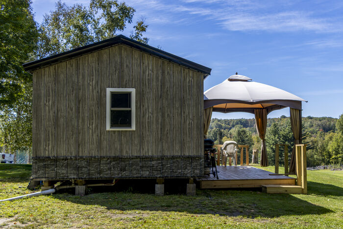 The end of the cabin with its window, and the gazebo and deck beside it