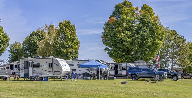 A wide view along a row of campers under open sky