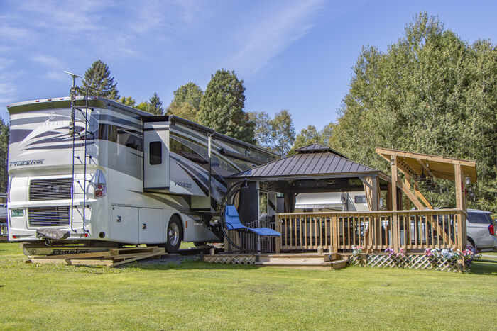 A motorhome with a covered deck and lattice skirting